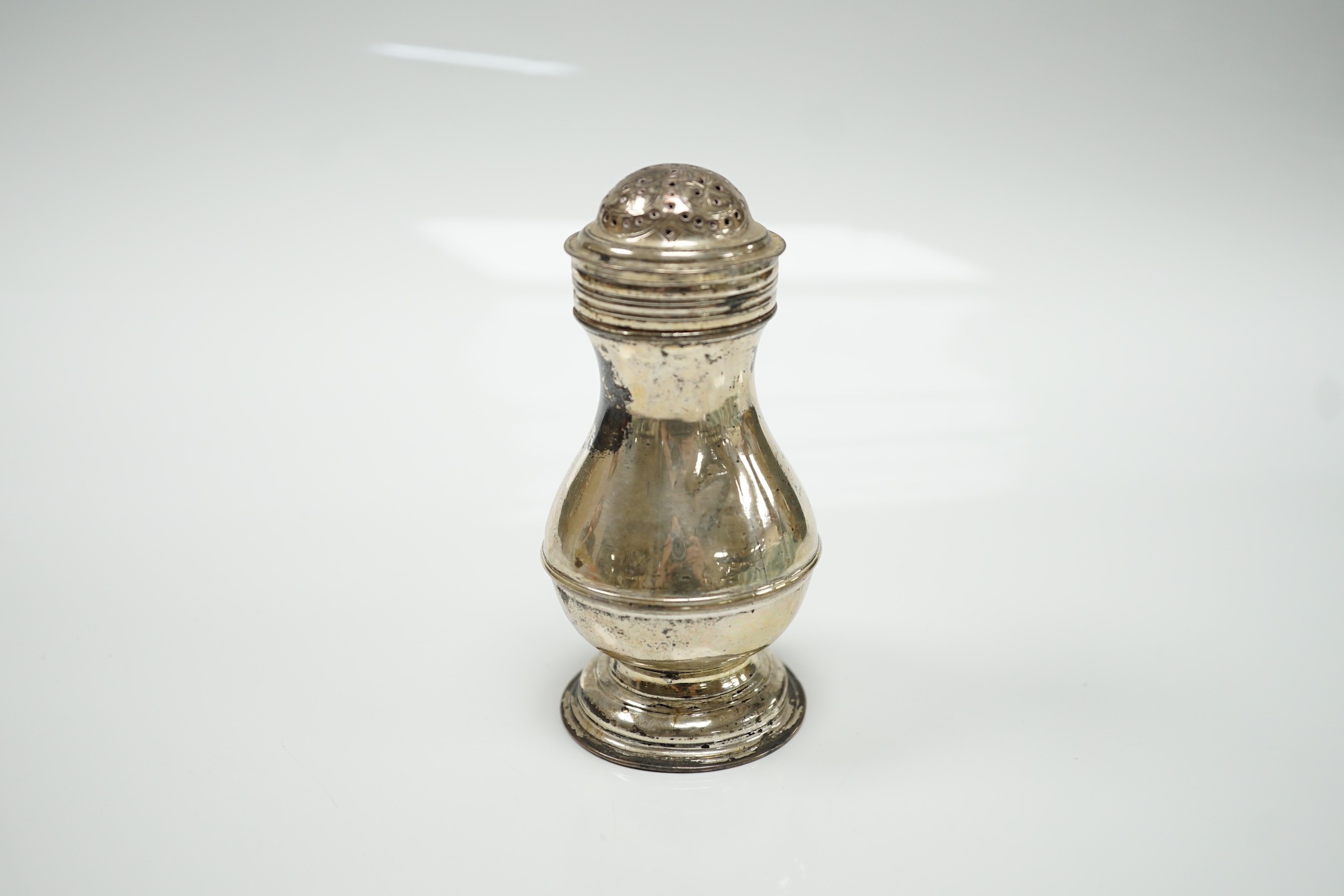An early George II silver pepperette, maker's mark rubbed, London, 1729, 10cm.